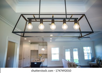 Hanging black metal iron modern chandelier lighting fixture with vintage bulbs  - Powered by Shutterstock
