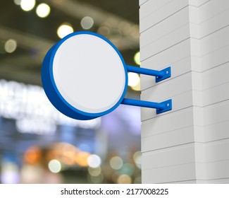 Hanging blue rounded signboard mockup over blur light and shadow of shopping mall, Light box signage, 3D rendering