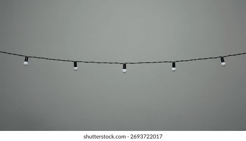 hanging bulb string lights on a grey background 