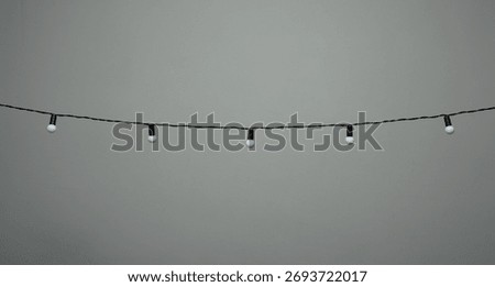 hanging bulb string lights on a grey background 