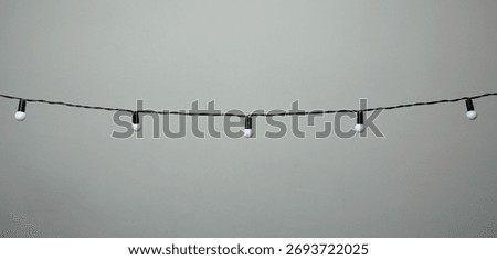 hanging bulb string lights on a grey background 