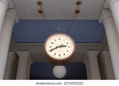 Hanging clock in a At Railroad Station in Prague. Time in Public place in Europe. Low Angle View. Accuracy concept - Powered by Shutterstock
