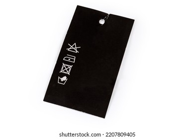 Hanging Clothes Tag In The Form Of The Black Carton Sheet With Hole And Pictured Clothing Care Symbols On A White Background
