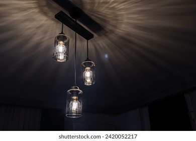 hanging dangling ceiling scones in front of a dark background