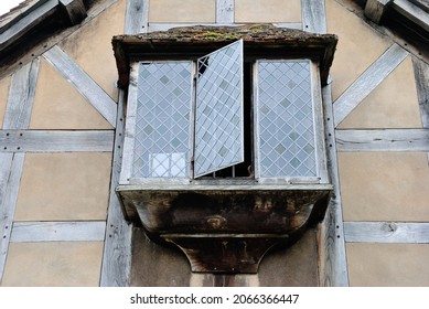 Hanging enclosed balcony with vintage glass windows in a historic half-timbered house in England, UK