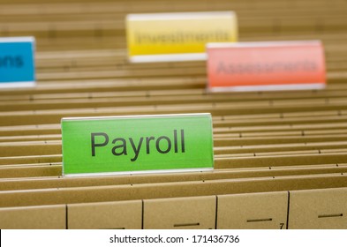 Hanging file folder labeled with Payroll