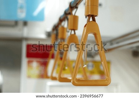 hanging handrail inside mass transportation interior as facility for passenger safety