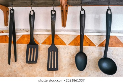 Hanging kitchen utensils kitchenware with shelf in Playa del Carmen Quintana Roo Mexico.