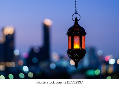 Hanging lantern with night sky and city bokeh light background for the Muslim feast of the holy month of Ramadan Kareem. - Powered by Shutterstock