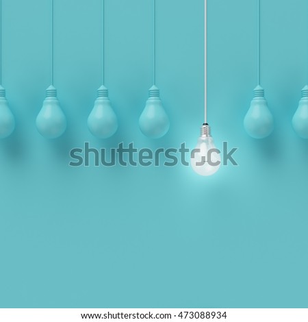 Hanging light bulbs with glowing one different idea on light blue background , Minimal concept idea , flat lay , top