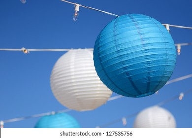 Hanging lights for a party with a blue sky background. - Powered by Shutterstock