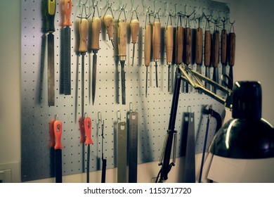 A Hanging Metal Pegboard Or Workbench, Full Of Tools To Craft And Repair Wood, A Very Wide Variety Of Tools Of The Trade. Angled View.
