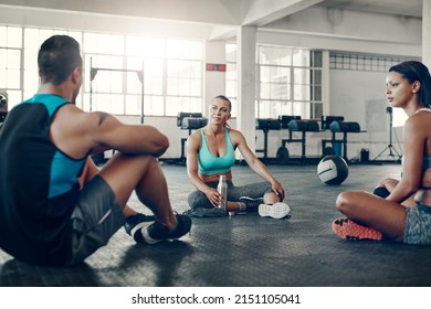 Hanging Out After Another Great Workout. Shot Of A Group Of Young People Taking A Break Together After A Workout At The Gym.