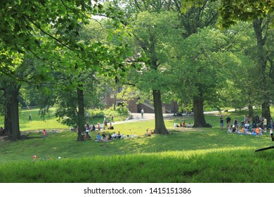 hanging out in prospect park in the late spring sun scores of people are out,  inside prospect park Brooklyn NY some just sun bathing others walking about Park opened in 1867, June 2 2019