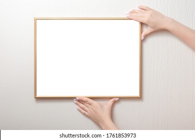 hanging a photo frame mockup on a white wall. Picture frame mockup