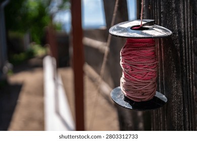 Hanging pink construction string on fence conctruction site.
