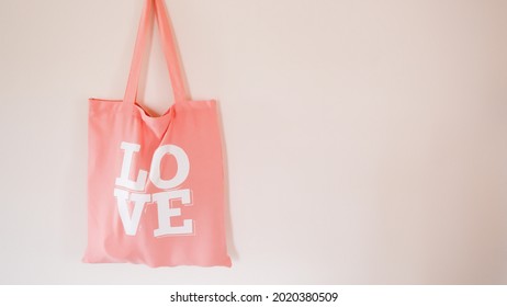 A hanging recyclable peach tote bag  - Powered by Shutterstock