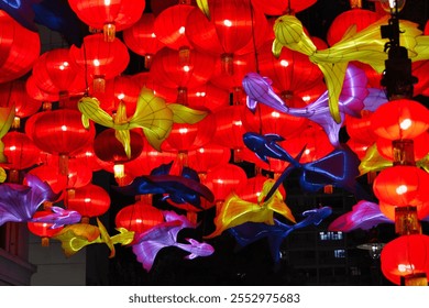 Hanging red lanterns are adorned with various colorful decorations. Yellow, blue, and purple elements accent the background of the red lanterns, creating a lively and vibrant visual effect.

 - Powered by Shutterstock