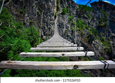 Hanging Rope Bridge Connecting Two Mountain Ranges.