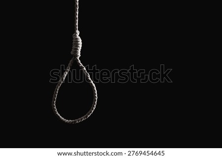 Hanging rope with loop on dark background. Suicide concept