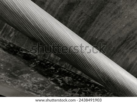 hanging a rope on another rope. cable-stayed pedestrian bridge, footbridge over the river stream. fencing of the footbridge with mesh and planks. detail of a strong steel rope from many strands