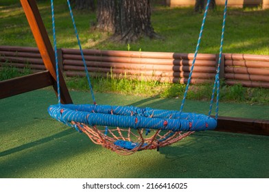 Hanging Rope Swing Near The House. A Place For Relaxation And Solitude. Comfortable Hammock Chair. Cozy Exterior Backyard. Concept Of Rest Outdoor.