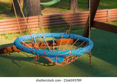 Hanging Rope Swing Near The House. A Place For Relaxation And Solitude. Comfortable Hammock Chair. Cozy Exterior Backyard. Concept Of Rest Outdoor.