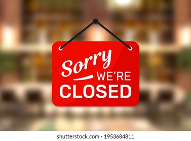 Hanging sign for shop with text Sorry we're closed on blurred restaurant background. - Shutterstock ID 1953684811