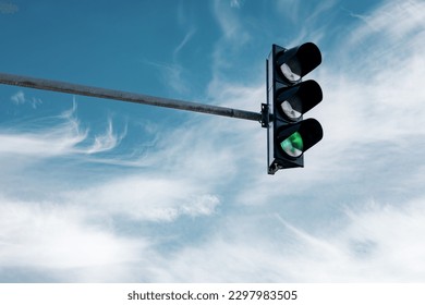 hanging traffic light against the sky 