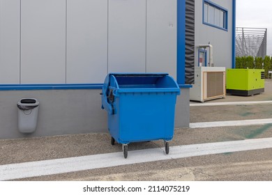 Hanging Trash Bin and Blue Wheeled Dumpster Recycling Warehouse
