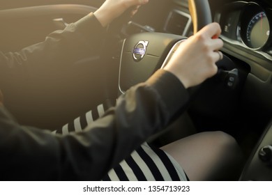 Hannover, Germany - 03 30 19 - Interior Of A Volvo Car Driven Fast By A Beautiful Woman In Short Skirt Showing Leg - Scene Floofed With Bright Sunlight - Feeling Good Lifestyle And Safety Concept 