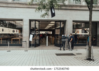 Hannover, Germany, 09.06.2020: Queue In Front Of An Apple Store During Corona Pandemic. Security Staff Is Measuring Fever Before Letting Customers In.