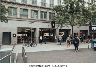 Hannover, Germany, 09.06.2020: Queue In Front Of An Apple Store During Corona Pandemic. Security Staff Is Measuring Fever Before Letting Customers In.