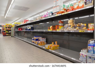 Hannover, Germany, 16.03.2020: Empty Shopping Shelves In The Supermarket. Customers Buy Groceries And Other Items On Stock With Fear Of The Corona Virus. Stock Buying, Noodles, Flour, Panic Shopping.