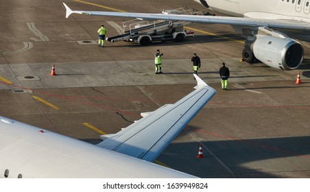 Hannover, Germany, February 8., 2020: Airport Ground Staff Working Between Two Aircraft On The Tarmac