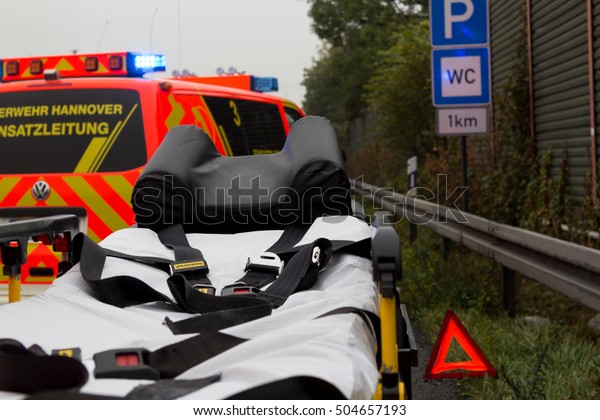 HANNOVER / GERMANY - OCTOBER 25, 2016:\
Emergency stretcher stands with a  german firefighting truck on\
freeway a2  by a truck crash near\
Hannover.