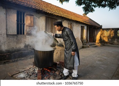 Hanoi, Vietnam - Jun 22, 2017: Cooking Chung cake outdoor in communal house at So village, Quoc Oai district. Square glutinous rice cake, Vietnamese lunar new year food