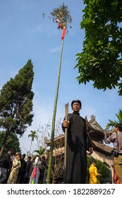 Hanoi, Vietnam - Jun 22, 2017: Raising Neu tree rituals in communal house at So village, Quoc Oai district. The bamboo pole placed in front of house on the last day of the lunar year to expel evils