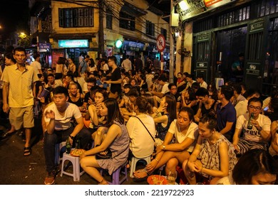 Hanoi, Vietnam - June 2016: A Crowded Street Corner In The Old Quarter Of The City Of Hanoi With Young People Enjoying Bia Hoi Aka Fresh Beer.