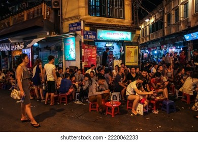 Hanoi, Vietnam - June 2016: A Crowded Street Corner In The Old Quarter Of The City Of Hanoi With Young People Enjoying Bia Hoi Aka Fresh Beer.