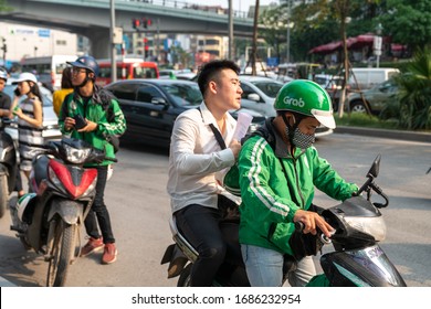 Hanoi, Vietnam - Mar 21, 2019: Grab Bike Taxi Man With Customer At Dao Tan Street