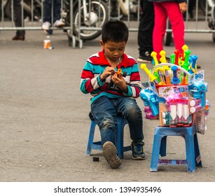 HANOI, VIETNAM, MAY 27, 2018: Child Selling Toys At Hanoi Central Square, Vietnam