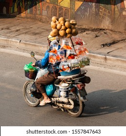 HANOI, VIETNAM, MAY 27, 2018: Vietnamese driving a motorbike and transporting a lot of packages. This is a typical vietnam transport with motorcycle or scooter
