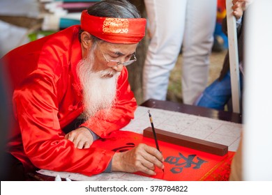 hanoi, vietnam: A scholar writes Chinese calligraphy characters at Temple of Literature on Feb 12,2016."Calligraphy giving" is a popular tradition during Tet holiday to Vietnamese people.