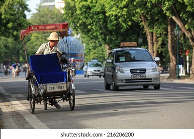 HANOI, VIETNAM - SEP 7, 2014: Popular type of transportation for foreign visitors in Vietnam, cyclo rickshaw and taxi, on Hanoi street,
