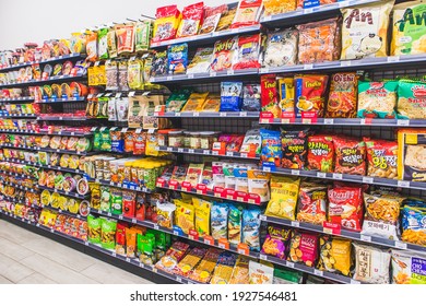 HANOI,VIETNAM - March 1,2021 -Many Snack And Candy Brand Sale On The Shelf In A Convenience Store,Variety Of Snack, Chips, Cookies, Crackers, Sweet On Supermarket Shelves Background.