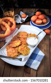 Hanukkah Dinner. Table With Traditional Dishes For Hanukkah, Latke, Hanukkah Honey Balls And Donuts. 