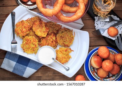 Hanukkah Dinner. Table With Traditional Dishes For Hanukkah, Latke, Hanukkah Honey Balls And Donuts. 