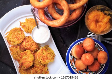 Hanukkah Dinner. Table With Traditional Dishes For Hanukkah, Latke, Hanukkah Honey Balls And Donuts. 