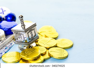 Hanukkah Dreidel And Gelt On The Table.